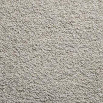 Textured light gray rug with dense granular surface and mottled appearance, displaying a uniform tactile quality under diffused lighting.